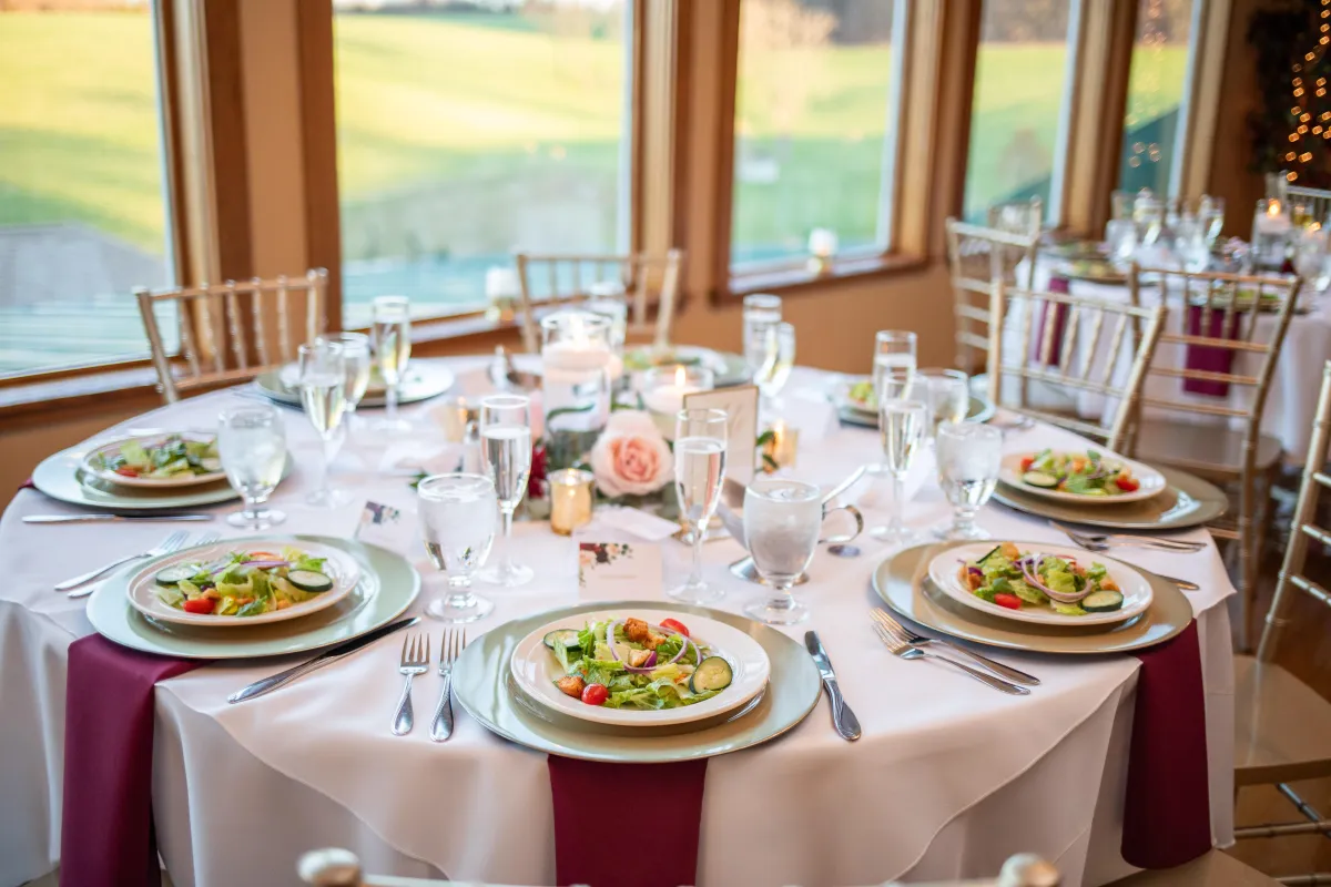 Outdoor wedding ceremony at Morningside Inn with white pergola, garden backdrop, and guests seated on the lawn