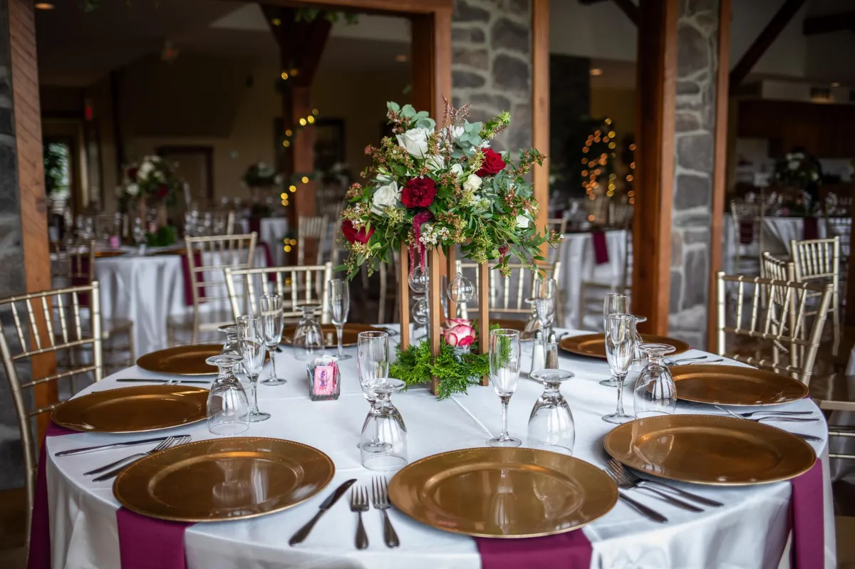 Wedding reception setup at Morningside Inn featuring a sweetheart table with floral arrangement, gold chiavari chairs, and panoramic views of rolling hills