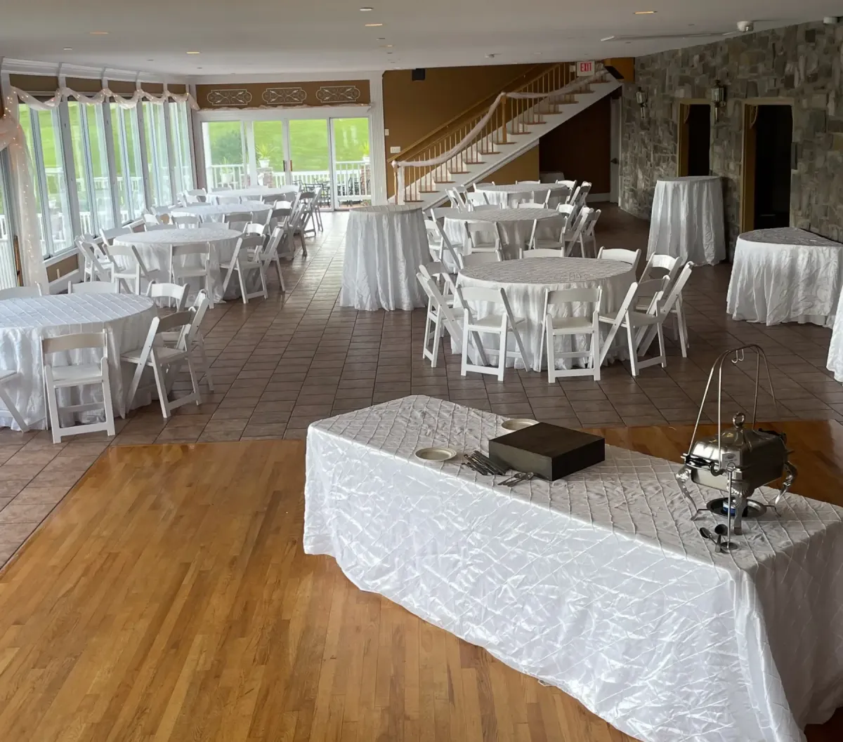 Indoor reception area at Morningside Inn featuring white tablecloths on round tables, elegant decor, and a buffet setup, ideal for wedding celebrations.