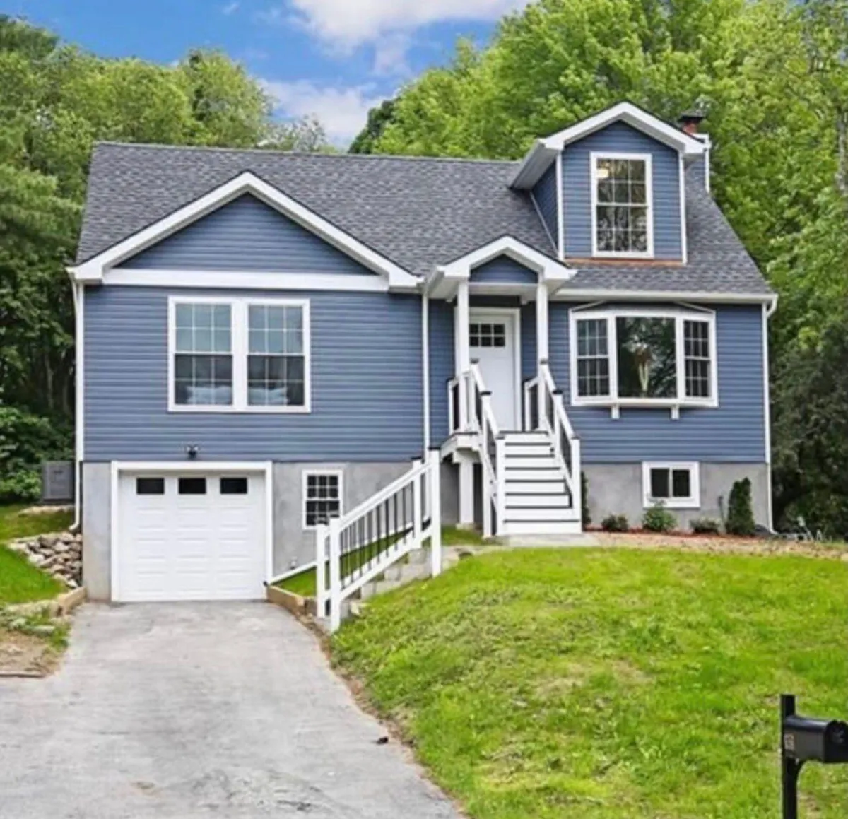 Finished full home transformation in Westchester County showing completed second story addition with expanded living space and fully renovated exterior on entire house