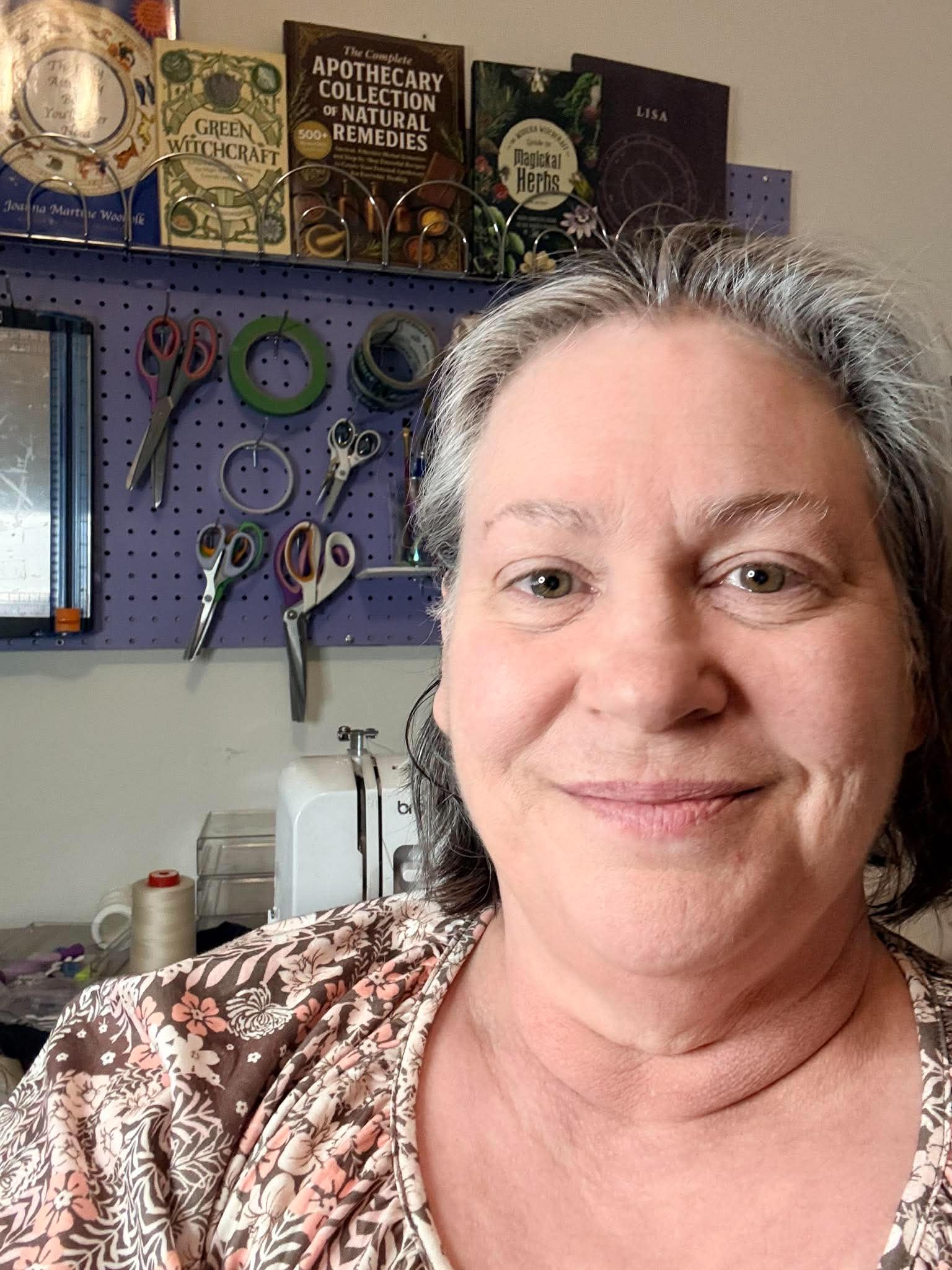 Warm studio portrait of Lisa, founder of Sew Tarot, hand-stitching a velvet tarot pouch
