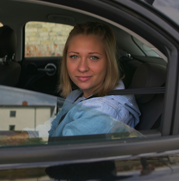 Happy customer sitting in their newly financed vehicle through Drive Access