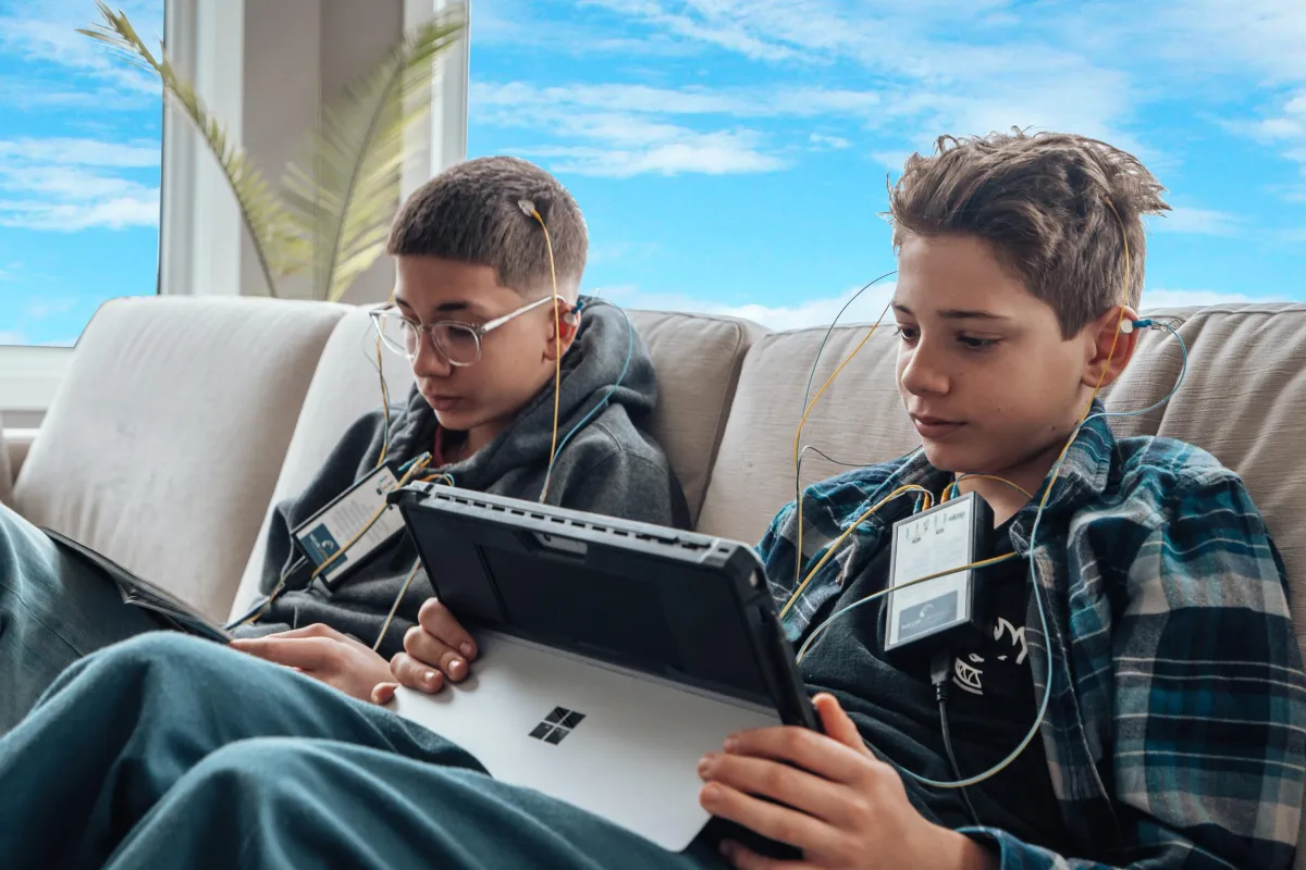 A pair of teenage boys in a NeurOptimal® neurofeedback session