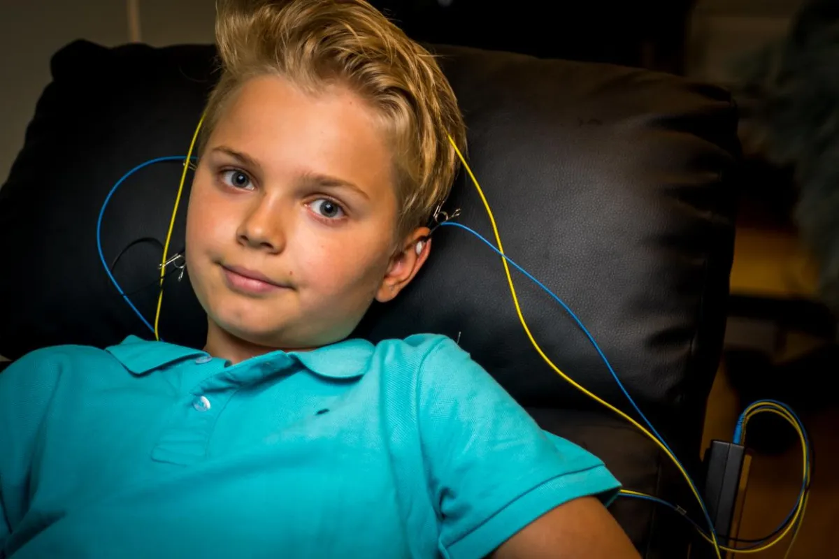 A happy boy as seen during an at home neurofeedback session