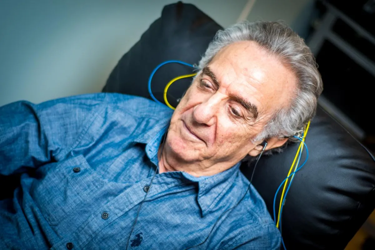 An elderly man focusing on an at home neurofeedback brain training session