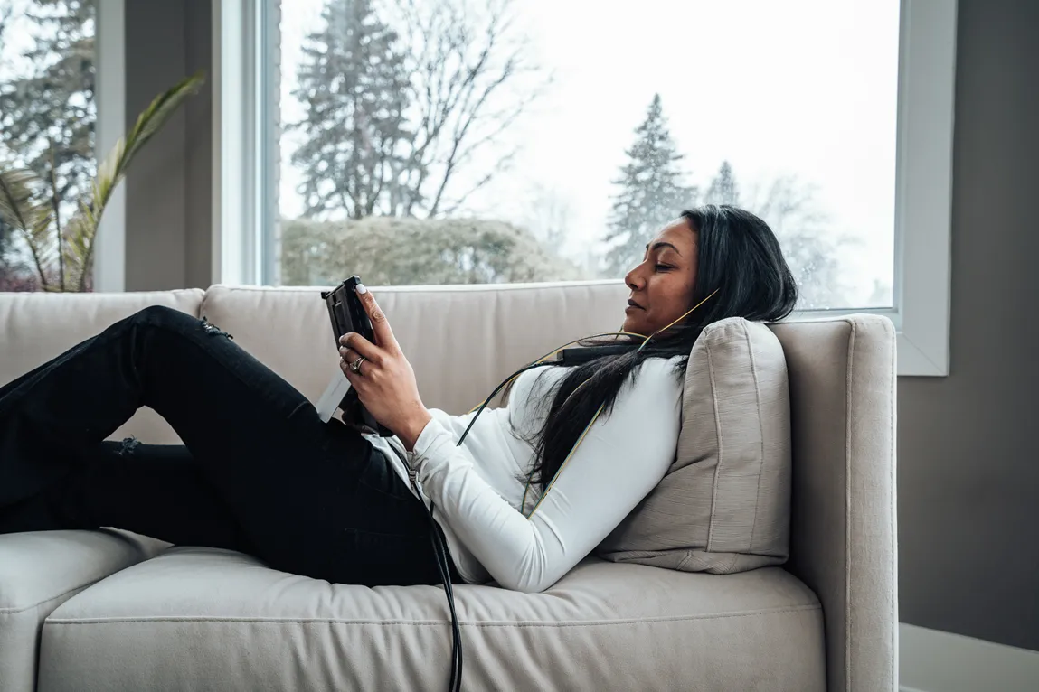 woman in a neurofeedback session reclining comfortably on a couch