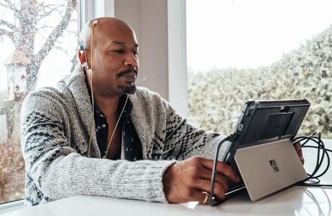 a man in a neurofeedback session seated at a table