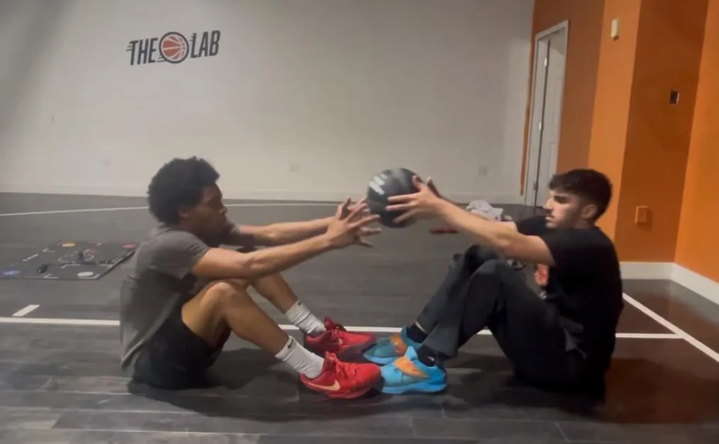2 men playing basketball during daytime