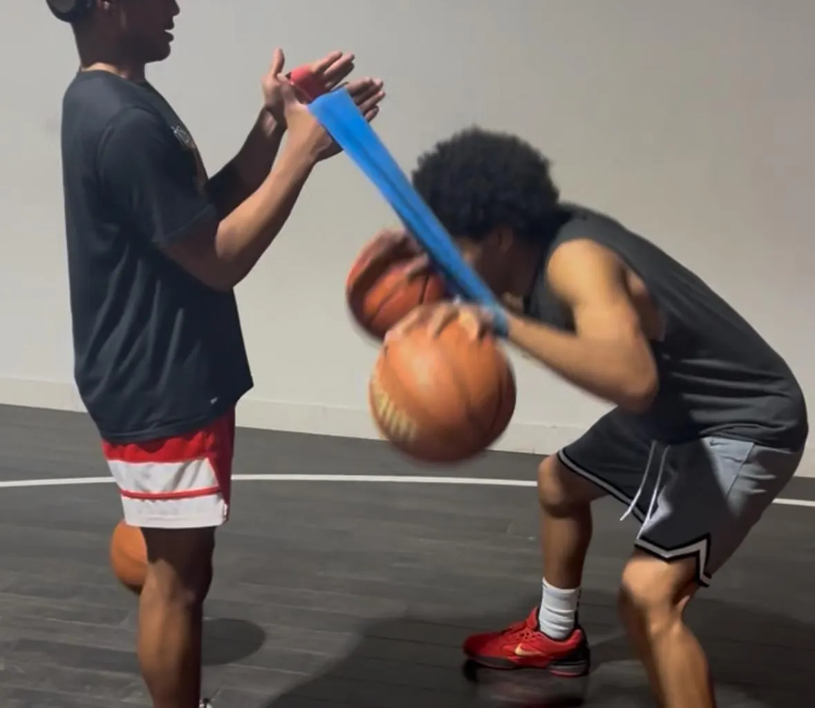 2 men playing basketball during daytime