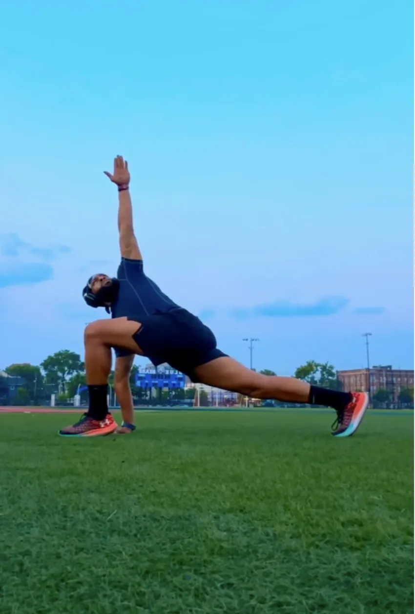 Woman practicing yoga on mat in autumn park