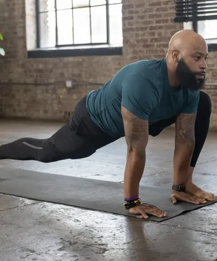 Woman stretching on yoga mat in autumn park