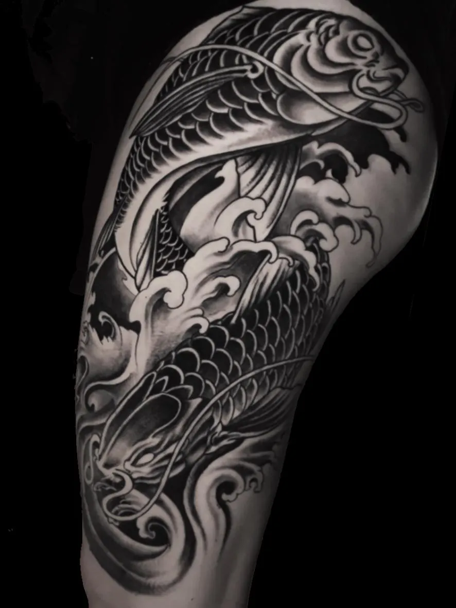 Black & gray koi fish thigh tattoo — a powerful cover-up blending Japanese waves with realism. By Alek the Saint in Point Loma, San Diego.