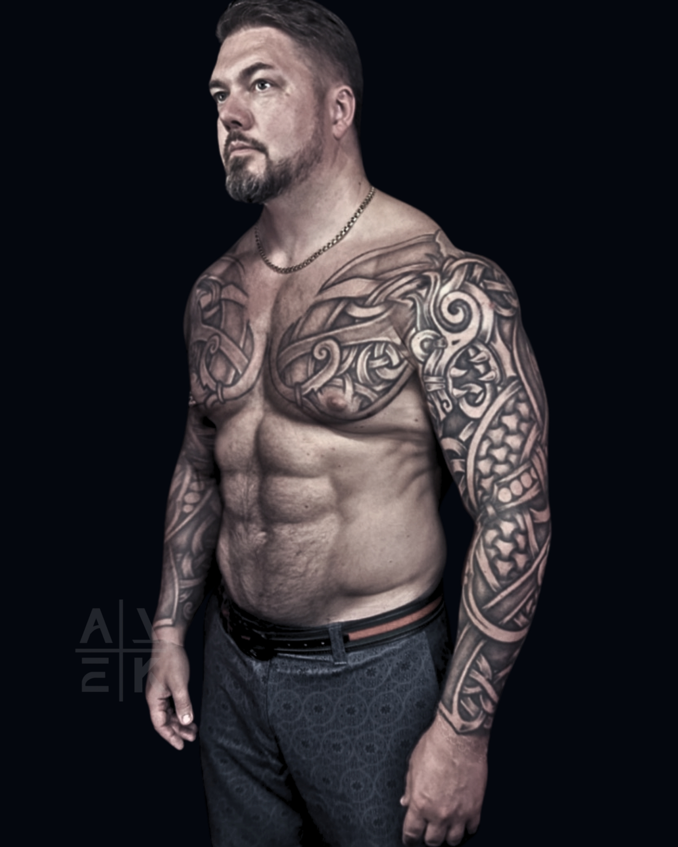 Black and grey ornamental tattoo sleeve and chest piece with bold contrast and flowing patterns on the upper body, tattooed by Alek the Saint at San Diego Tattoo Company in Pacific Beach, San Diego