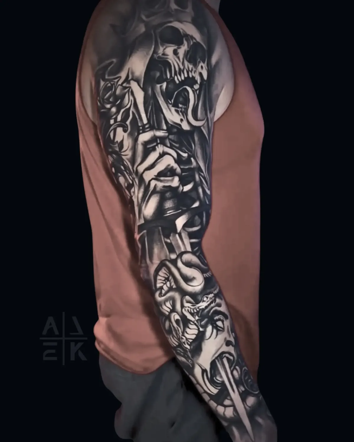 Blackwork sleeve tattoo of the Lich King’s sword piercing Medusa, featuring skulls and fantasy realism by Alek the Saint, Oceanside, Ca