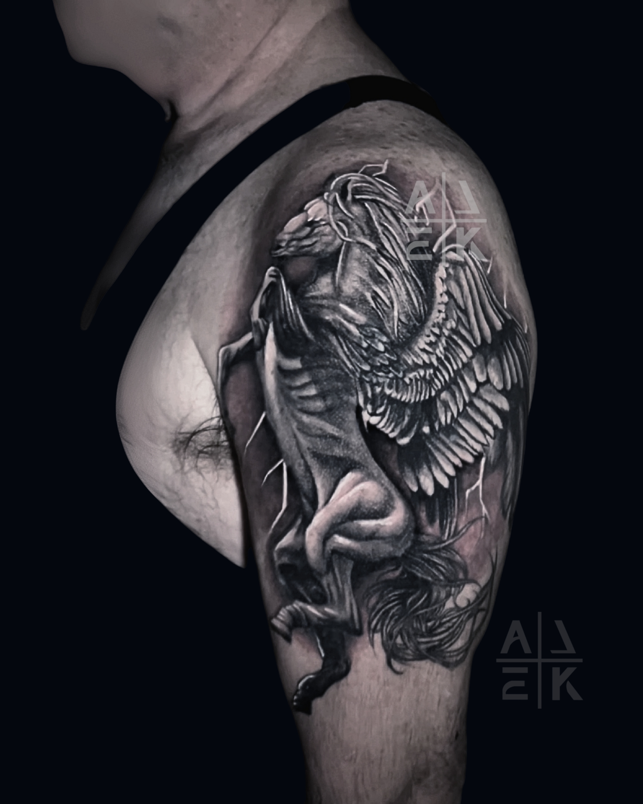 Sunflower shoulder tattoo in hyper-realism with bold outline and graphic linework leaves, covering unicorn tattoo. By Alek the Saint, Oceanside, Ca