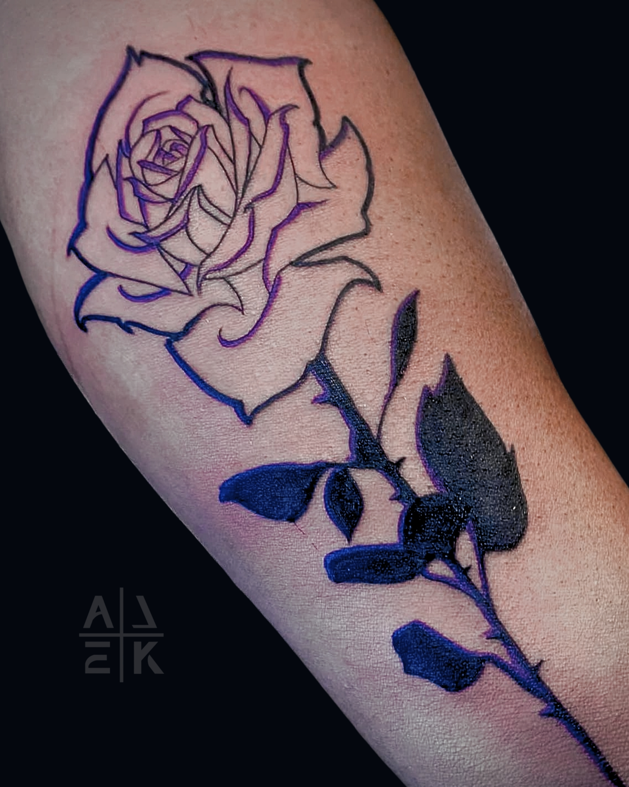 Realistic pink rose tattoo with smooth gray shading and clean edges — color realism by Alek the Saint in Oceanside, Ca