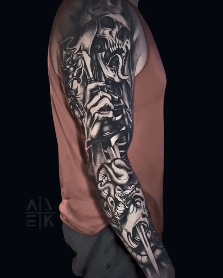 Blackwork sleeve tattoo of the Lich King’s sword piercing Medusa, featuring skulls and fantasy realism by Alek the Saint, Escondido ca