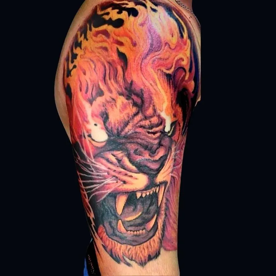 flaming lion tattoo in color realism on the shoulder in Oceanside, California