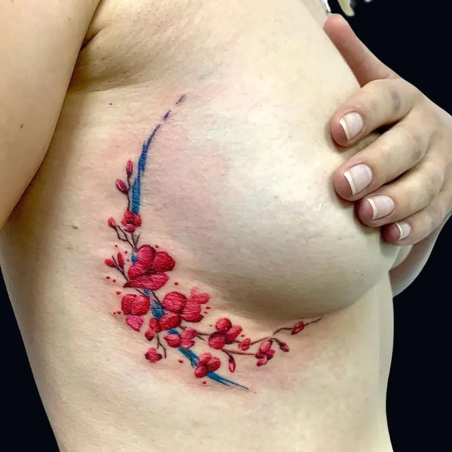 , color realism tattoo of a cherry blossom on the ribs in Oceanside, California