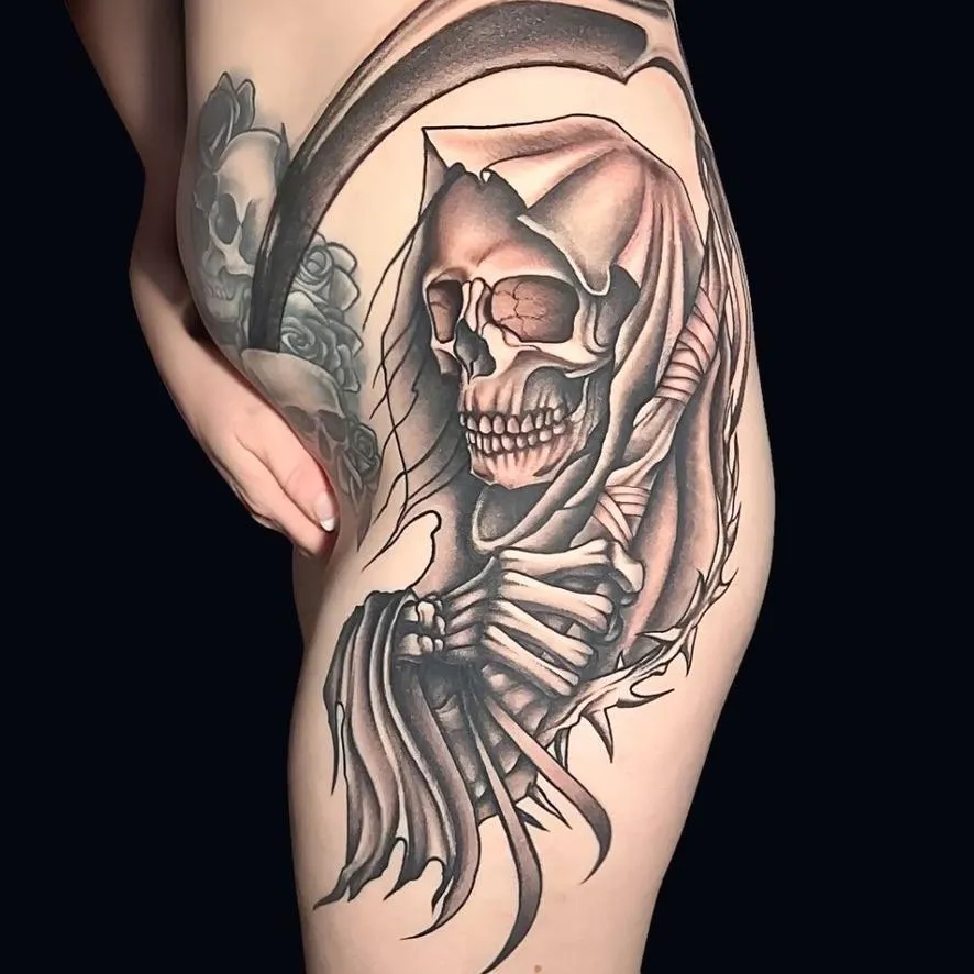 a black and gray large hip tattoo of a Grim Reaper in Oceanside, California