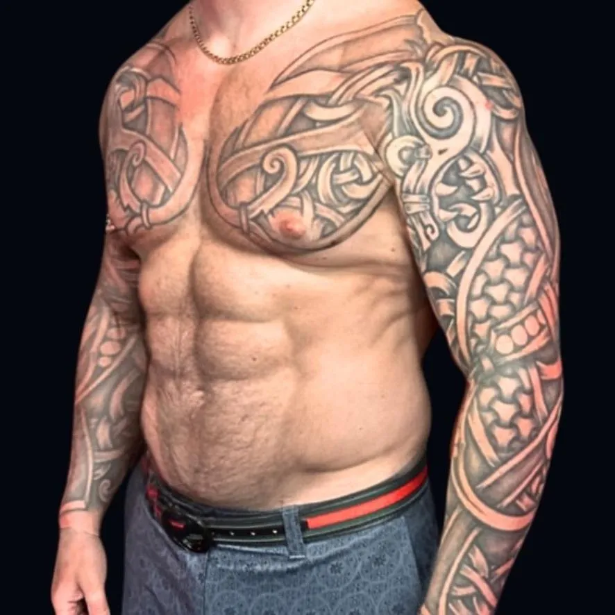 A black work tattoo two sleeves and the chest pieces, Viking ornamental in Oceanside, California