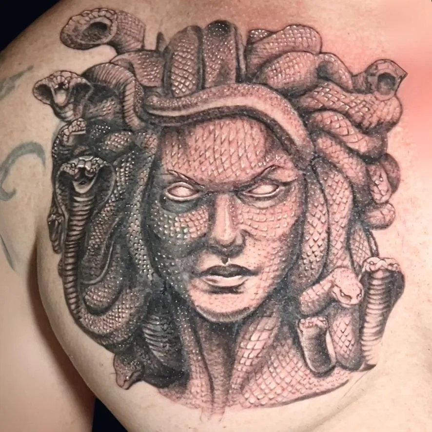 highly detailed tattoo of Medusa on the chest. It's a cover-up in black and gray in Oceanside, California.