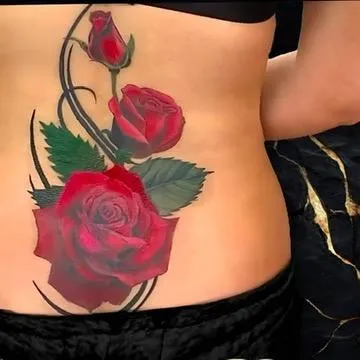 Color realism rose tattoo, cover up of a tram stamp on the lower backdone by Alek the Saint tattoo artist in Oceanside, California
