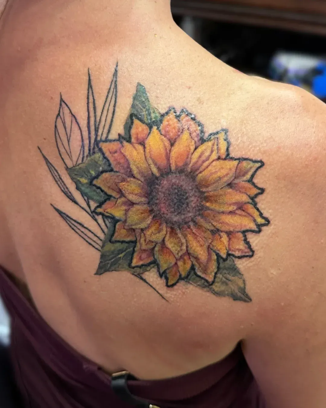 , realism, tattoo, cover-up of sunflower, a color realism, cover-up of what used to be a unicorn covered by a color realism tattoo of a sunflower with elements of tradition in Oceanside, California done by the Saint