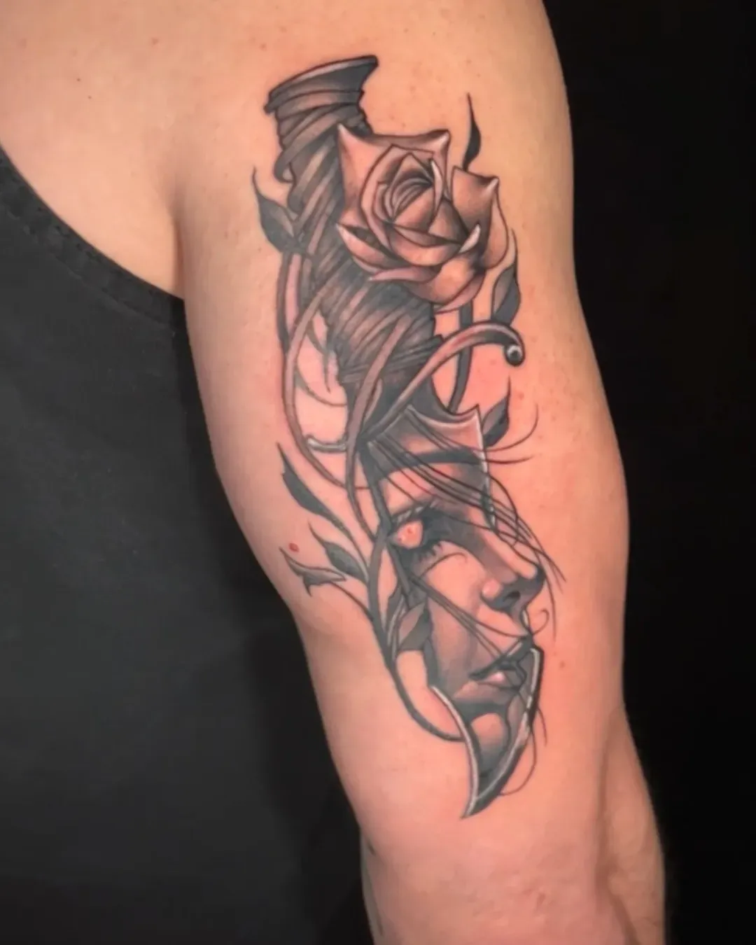 Black and gray knife tattoo On the tricep done by the Saint in Oceanside, California