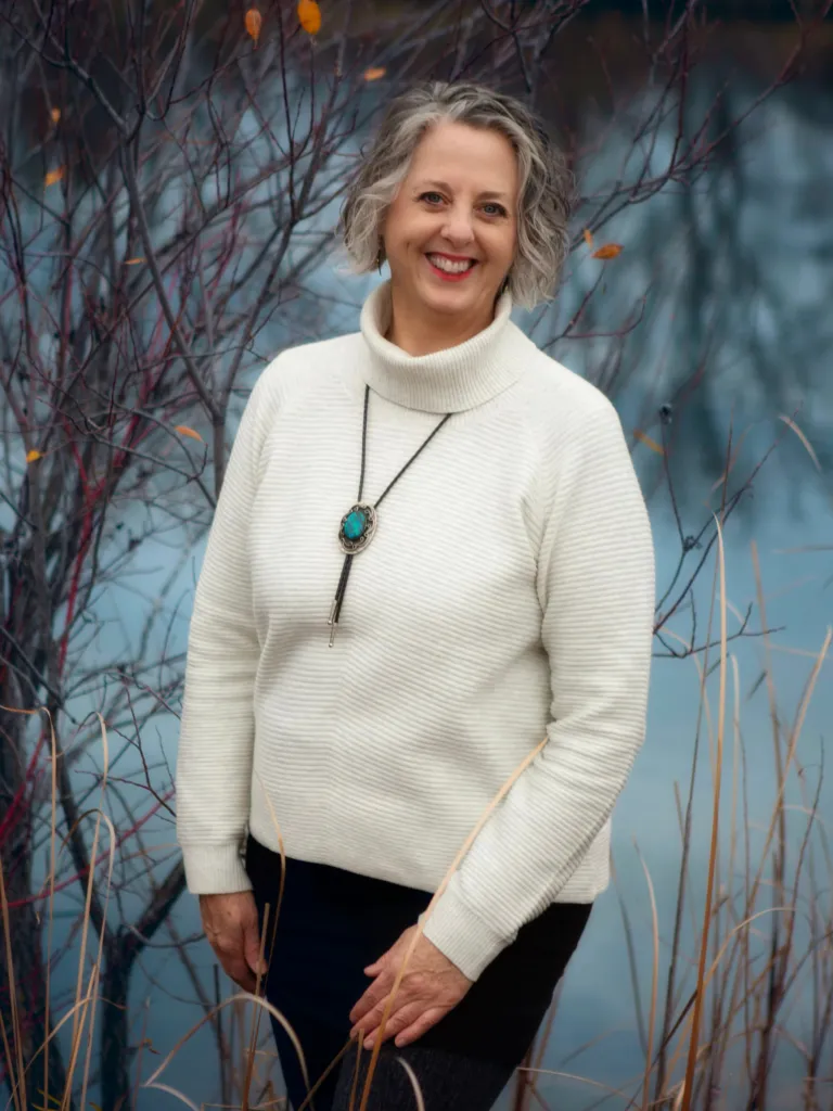 Portrait of Dr. Bell in a warm, professional wellness clinic setting