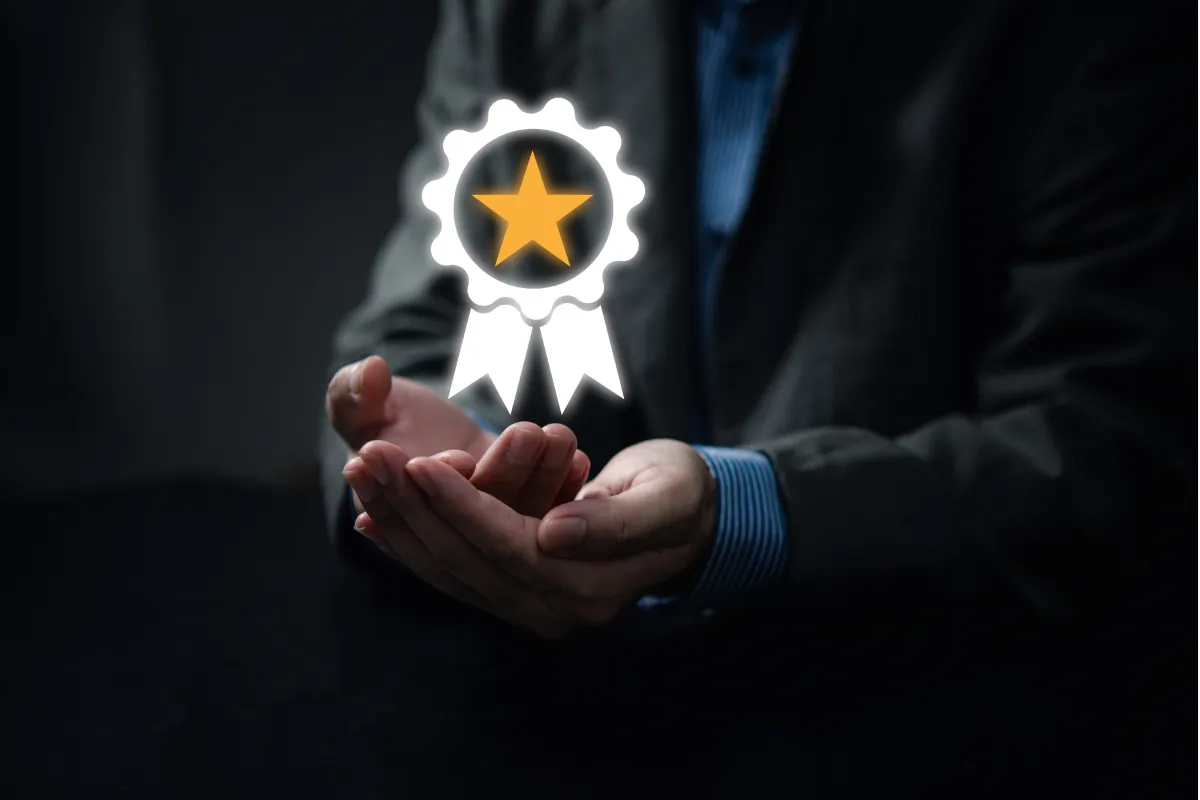 A person in a suit holding an illuminated badge icon with a star, symbolizing excellent customer service and quality assurance.