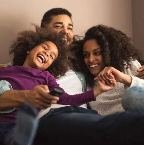 Young Black family enjoying time together, representing the importance of life insurance in protecting loved ones and building a secure financial future.