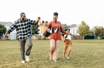 Young Black family enjoying time together, representing the importance of life insurance in protecting loved ones and building a secure financial future.