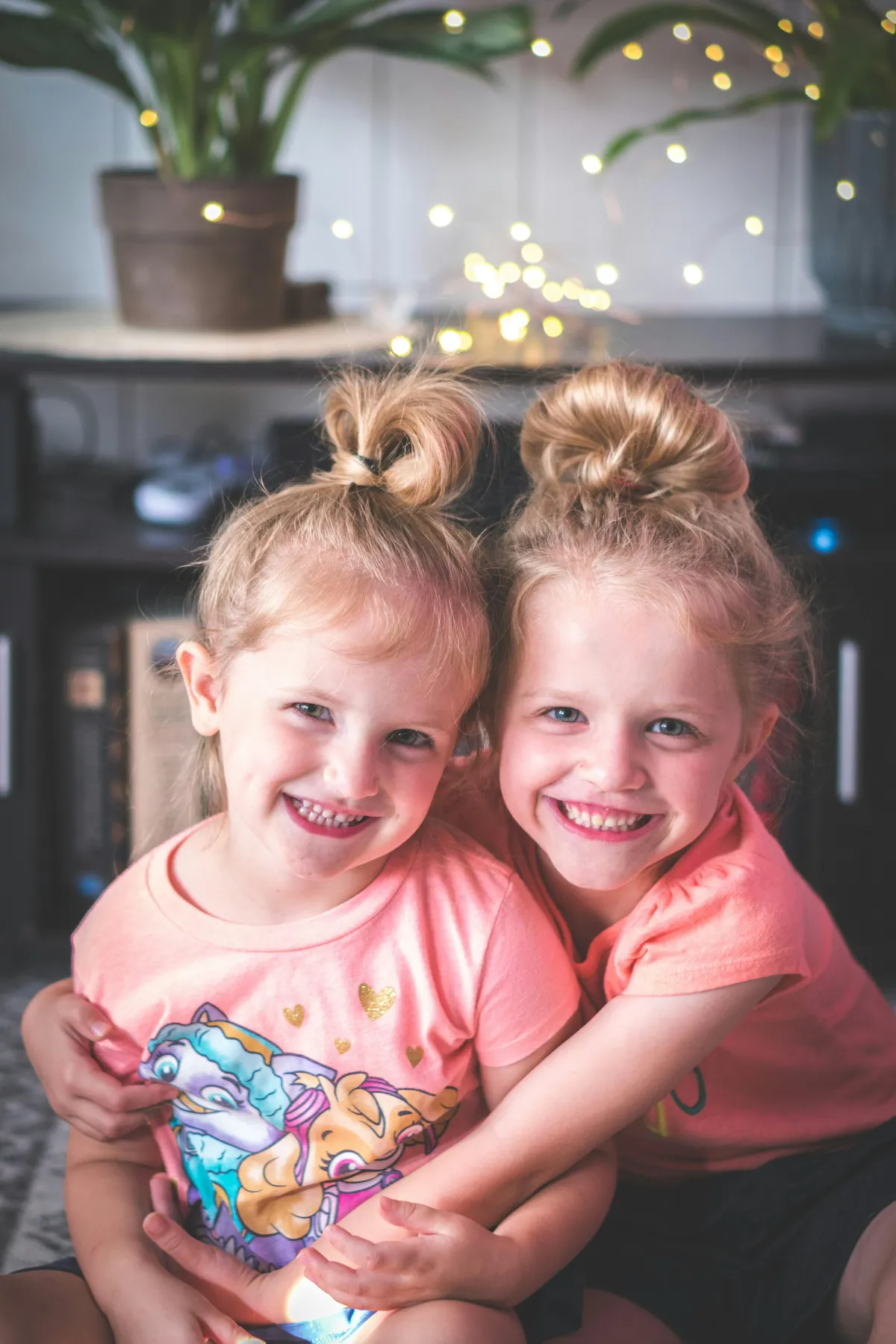 Two young girls hugging and smiling, representing the love and security that comes from life insurance protection for families.