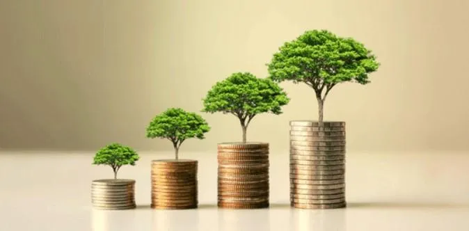 Coins stacking higher with trees growing out of them, symbolizing the growth potential and financial prosperity associated with Indexed Universal Life Insurance.