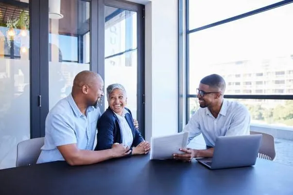 Happy couple reviewing their annuity plans with their financial consultant.