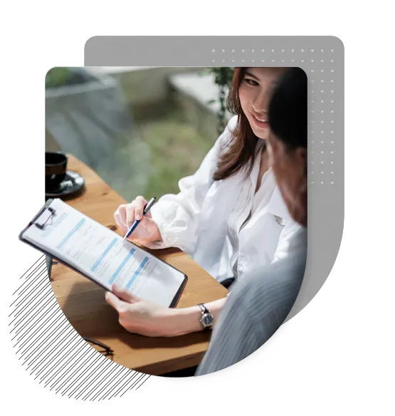 Young woman holding a clipboard with an application and pen, consulting with a man about ACA health insurance options.