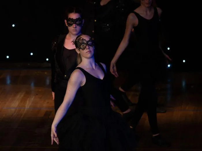 Senior dancers from Junior Elite & Dance Elite classes in dramatic black costumes during the 2024 MGA performance.