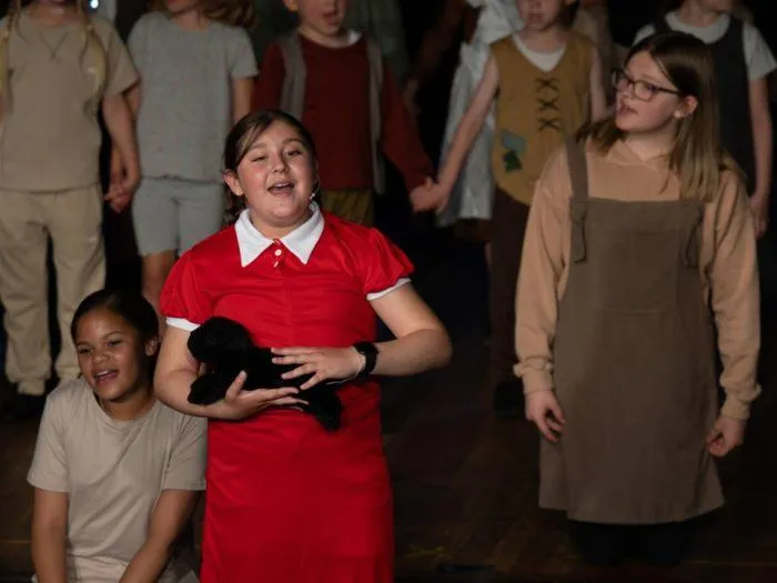 Children performing a musical theatre number in costume during an MGA singing showcase