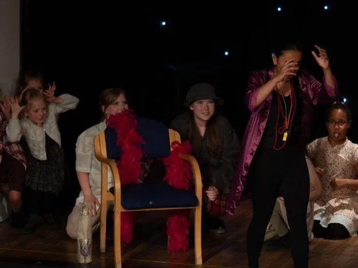 Children performing a playful group scene on stage at the 2024 MGA showcase
