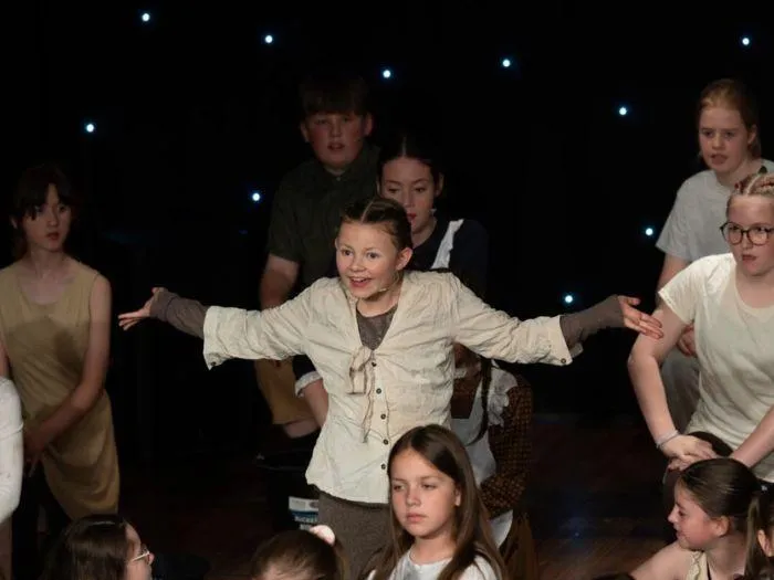Young actors in dynamic stage performance developing storytelling and confidence