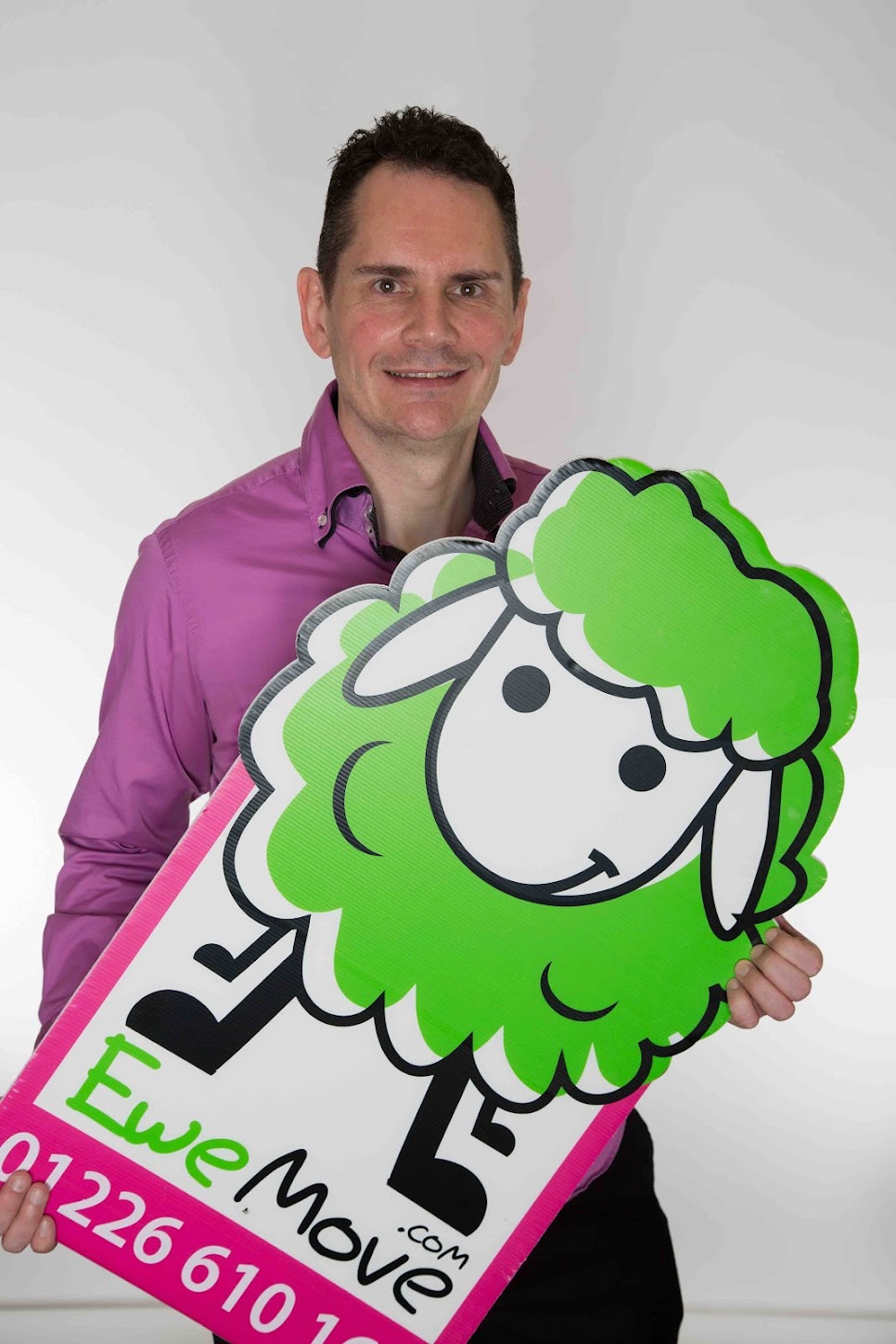 Glenn holding a EweMove sign