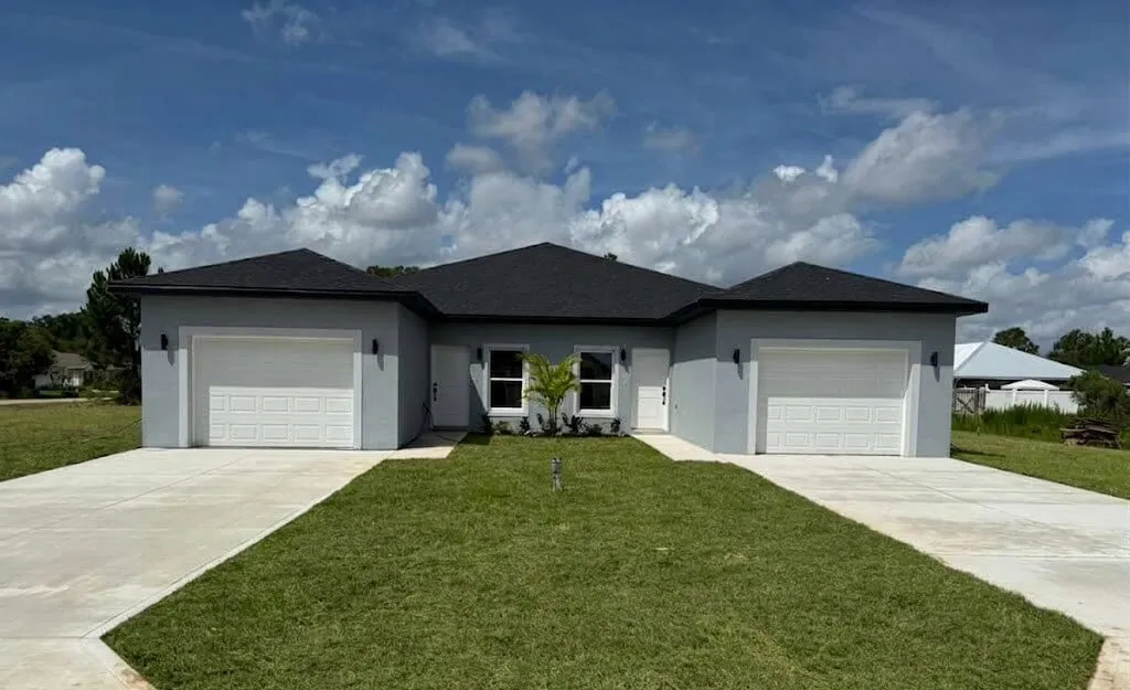 Duplex home exterior featuring a modern single-story design