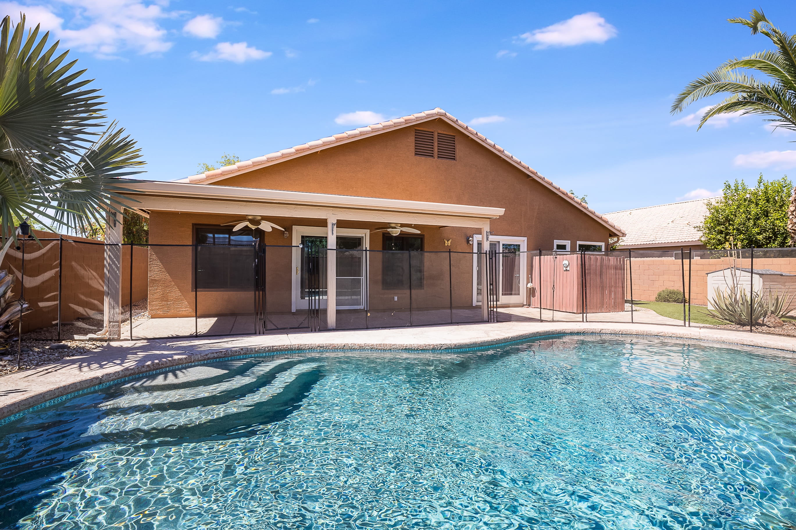 Gilbert backyard covered patio with a pool