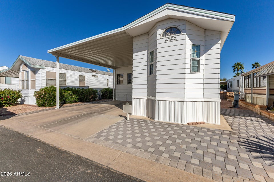 white house with covered car port 