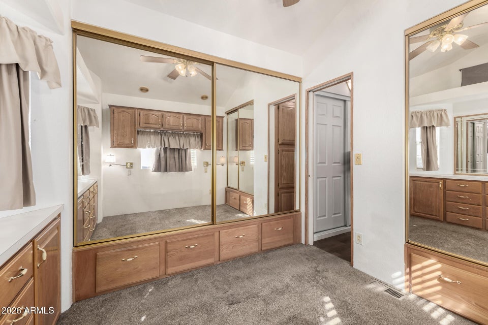 bedroom with mirror closet doors 