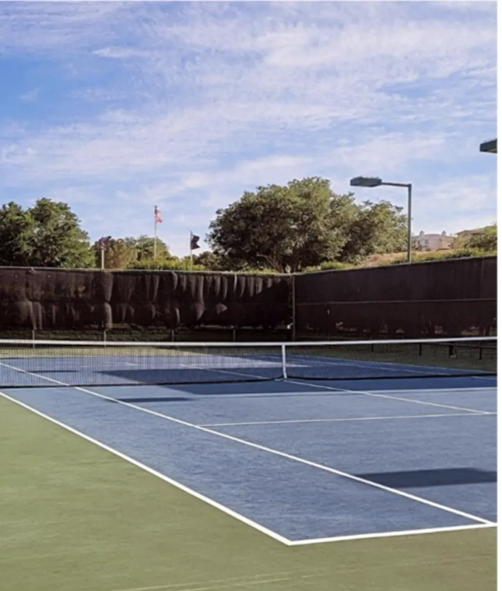 white golf ball on top of green grass field surrounded by green leaf trees
