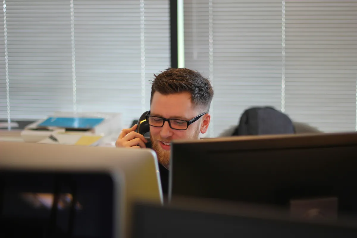 Business owner on the phone at a desk with a computer