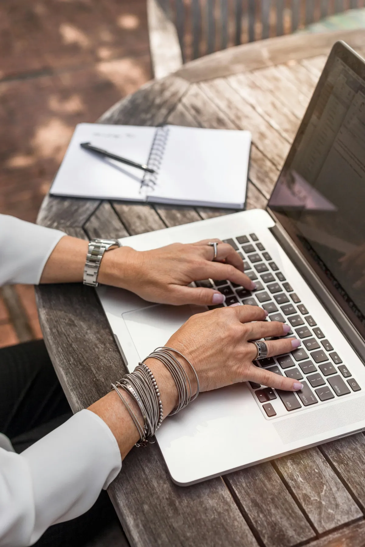 Close-up of hands typing on a laptop keyboard