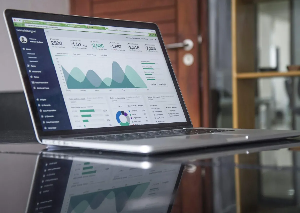 Laptop screen showing a software dashboard with charts
